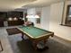 Spacious game room with a pool table, bar area, and comfortable seating for entertainment at 545 Walnut Woods Dr, Greenwood, IN 46142