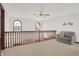 Upstairs hallway with seating area and two arched windows at 545 Walnut Woods Dr, Greenwood, IN 46142