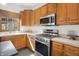 Well-equipped kitchen featuring wood cabinets, stainless steel appliances, and a bright window at 545 Walnut Woods Dr, Greenwood, IN 46142