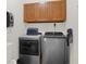 Functional laundry room featuring modern washer and dryer units, storage cabinets, and ample space at 545 Walnut Woods Dr, Greenwood, IN 46142