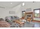 Bright living room with a cozy fireplace, large windows, and hardwood floors at 545 Walnut Woods Dr, Greenwood, IN 46142