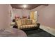 Finished basement media room with couches, black carpet and movie decor at 545 Walnut Woods Dr, Greenwood, IN 46142