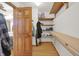 Organized walk-in closet features built-in shelving and wooden floors at 545 Walnut Woods Dr, Greenwood, IN 46142