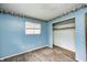Well-lit bedroom with blue walls and closet, perfect for relaxation and storage at 5558 Bertha St, Indianapolis, IN 46241