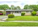 Cozy single-story home featuring a well-maintained lawn, attached garage, and charming curb appeal at 5558 Bertha St, Indianapolis, IN 46241
