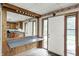 View into the kitchen reveals the cabinetry, sink, and countertop workspace with a white door at the end at 5558 Bertha St, Indianapolis, IN 46241