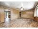Open living room featuring hardwood floors and paneled walls with a view into the kitchen at 5558 Bertha St, Indianapolis, IN 46241