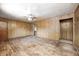 Large living room showcasing hardwood floors, paneled walls, and a ceiling fan fixture at 5558 Bertha St, Indianapolis, IN 46241