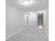 Bonus room featuring neutral carpet, modern lighting, and access to a finished storage area at 5790 Arcade Blvd, McCordsville, IN 46055