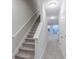 Bright hallway with carpeted stairs leading to a living room with sliding glass doors at 5790 Arcade Blvd, McCordsville, IN 46055