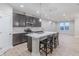 Spacious kitchen with bar seating at island, modern lighting, and stainless appliances at 5790 Arcade Blvd, McCordsville, IN 46055
