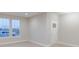 Clean, bright, and neutral living room with a large window, new flooring and a white front door at 5790 Arcade Blvd, McCordsville, IN 46055