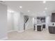 Open-concept living area boasts a spacious kitchen, staircase, and modern finishes at 5790 Arcade Blvd, McCordsville, IN 46055
