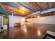 Spacious basement with exposed wood ceiling, concrete walls and floors, and a stairwell at 5903 Schoolwood Dr, Speedway, IN 46224