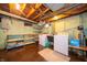 This unfinished laundry room boasts a washer, dryer, utility sink, and a vintage aesthetic at 5903 Schoolwood Dr, Speedway, IN 46224