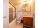 Classic bathroom with tiled shower, white fixtures, and wood vanity at 5903 Schoolwood Dr, Speedway, IN 46224