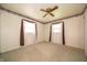 Bedroom featuring neutral carpet, dual windows with curtains, and floral wallpaper trim at 5903 Schoolwood Dr, Speedway, IN 46224