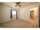 Bedroom with neutral carpet, ceiling fan, closet, window, and blue curtains at 5903 Schoolwood Dr, Speedway, IN 46224