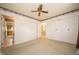 Bright bedroom with closet, neutral carpet, and decorative wallpaper border at 5903 Schoolwood Dr, Speedway, IN 46224