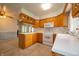 Traditional-style kitchen featuring wooden cabinets, white appliances, and tile backsplash at 5903 Schoolwood Dr, Speedway, IN 46224
