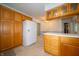 Bright kitchen showcases ample wood cabinetry and counter space, including a large refrigerator at 5903 Schoolwood Dr, Speedway, IN 46224