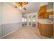 Cozy kitchen eating area with hardwood cabinets, sliding doors, and carpet flooring at 5903 Schoolwood Dr, Speedway, IN 46224