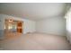 Spacious living room with neutral carpet, bright walls, and natural light at 5903 Schoolwood Dr, Speedway, IN 46224