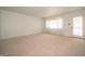 Comfortable living room featuring carpet, bright walls, and exterior door at 5903 Schoolwood Dr, Speedway, IN 46224