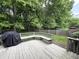 This back deck has a bench, grill, and is surrounded by mature trees and a fenced in backyard at 6366 Stratford N Dr, Fishers, IN 46038