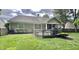 The backyard has a wooden deck, green lawn, and a beige house with a screened-in porch at 6366 Stratford N Dr, Fishers, IN 46038