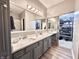 Modern bathroom with dual sinks, luxurious vanity, and walk-in closet at 6366 Stratford N Dr, Fishers, IN 46038