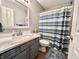 The bathroom features a blue and green striped shower curtain and a grey vanity with a white countertop at 6366 Stratford N Dr, Fishers, IN 46038