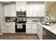 Modern kitchen featuring white cabinets, stainless steel appliances, and beautiful countertops at 6366 Stratford N Dr, Fishers, IN 46038