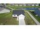 An aerial perspective features a charming home near a tranquil pond, set within a welcoming community, complete with a lush lawn at 637 N Quartz Ln, Fortville, IN 46040