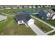 Aerial view of a cozy home with siding and brick, a two-car garage, and an outdoor pond that creates a picturesque neighborhood at 637 N Quartz Ln, Fortville, IN 46040