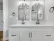 Beautiful bathroom featuring double sinks, quartz countertop, and arched mirrors at 637 N Quartz Ln, Fortville, IN 46040