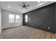 Bright bedroom featuring wood floors, a trey ceiling with fan, and decorative wall at 637 N Quartz Ln, Fortville, IN 46040