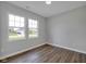 Empty bedroom with two bright windows and LVP flooring at 637 N Quartz Ln, Fortville, IN 46040