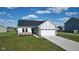 This delightful home showcases appealing siding, tasteful brick details, a two-car garage, and a neatly manicured lawn for curb appeal at 637 N Quartz Ln, Fortville, IN 46040