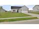 Charming single-Gathering home featuring a two-car garage, manicured lawn, and stylish gray siding at 637 N Quartz Ln, Fortville, IN 46040