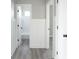 Hallway view showcasing doors with black hardware and board and batten accent wall at 637 N Quartz Ln, Fortville, IN 46040
