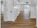 Elegant hallway featuring wood floors, white wainscoting, and views into the spacious living area at 637 N Quartz Ln, Fortville, IN 46040
