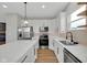 Modern kitchen featuring white cabinets, stainless steel appliances, and an island at 637 N Quartz Ln, Fortville, IN 46040