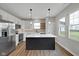 Bright kitchen with white cabinetry, a central island, and stainless steel appliances at 637 N Quartz Ln, Fortville, IN 46040