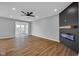 Bright living room featuring wood floors, recessed lighting, and a modern fireplace with a wood mantle at 637 N Quartz Ln, Fortville, IN 46040