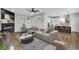 Cozy living room with a modern fireplace, plush seating, and an open concept view into the kitchen at 637 N Quartz Ln, Fortville, IN 46040