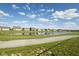 A tranquil pond reflects the sky amidst a neighborhood with lush green spaces and walking paths, enhancing the community's charm at 637 N Quartz Ln, Fortville, IN 46040