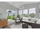 Bright sunroom with ample windows, comfortable seating, and a view of the backyard at 637 N Quartz Ln, Fortville, IN 46040