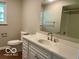 Bright bathroom with a large vanity, mirror and wooden floors at 6373 E Hadley Rd, Mooresville, IN 46158