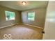 Empty bedroom featuring carpet and two bright windows at 6373 E Hadley Rd, Mooresville, IN 46158